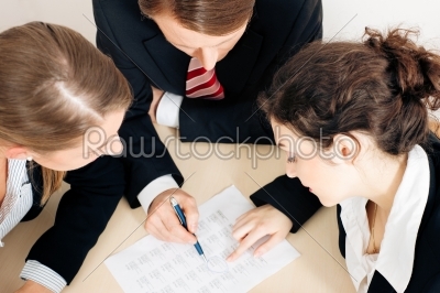 Businesspeople working on spreadsheet