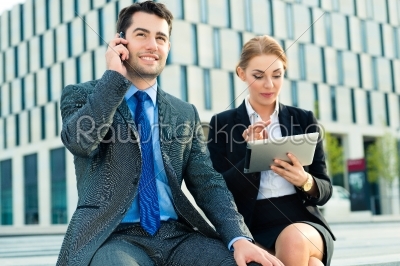 Businesspeople working outdoor with tablet computer