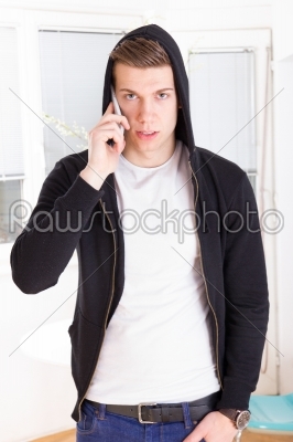 casual focused man with hooded on the phone