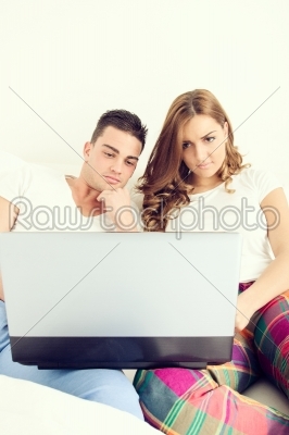casual young couple enjoying using laptop