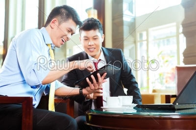 Chinese businessmen at business meeting in hotel
