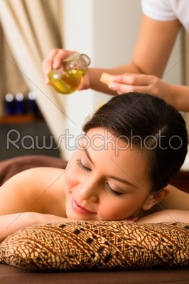 Chinese Woman at wellness massage with essential oils
