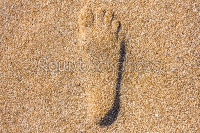 close up of footstep in sandy on the beach