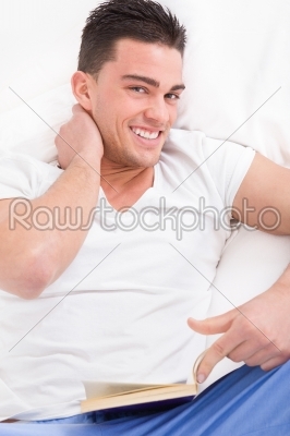 closeup portrait of handsome man in bed with neck pain