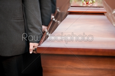 coffin bearer carrying casket at funeral