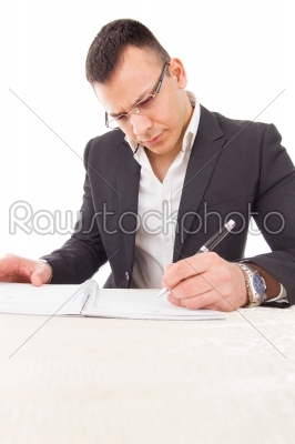 concentrated thoughtful professor writing evaluation and adding 