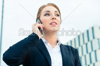 Confident businesswoman talking on business phone 