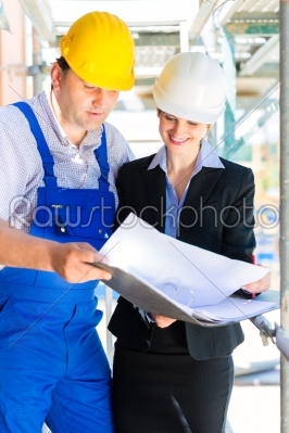 Construction Team with building plans on site
