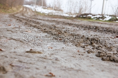 country road with mud and snow on the side