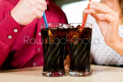 Couple drinking soda in a bar or restaurant