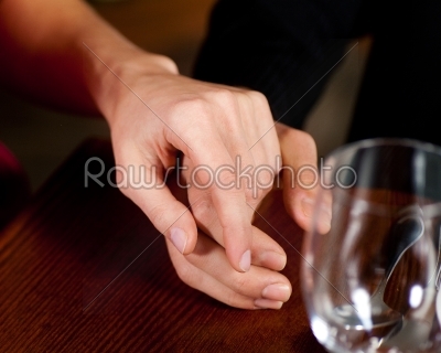 Couple holding hands on a table