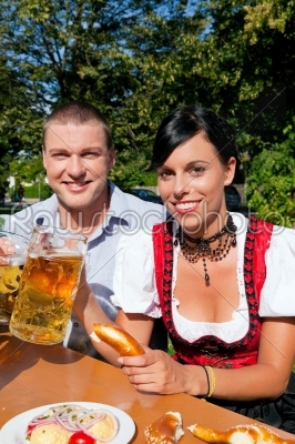 Couple in beer garden eating and drinking