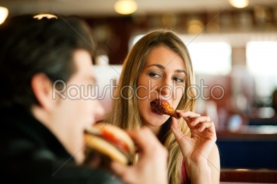 Couple in Restaurant eating fast food