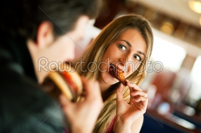 Couple in Restaurant eating fast food