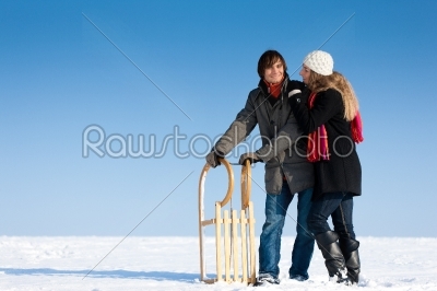 Couple in winter with sled