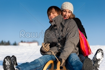 Couple in winter with sled