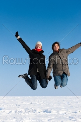Couple jumping on a winter day