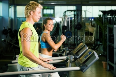Couple on treadmill in gym