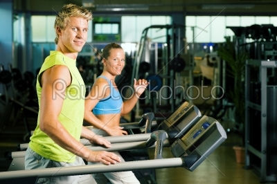 Couple on treadmill in gym