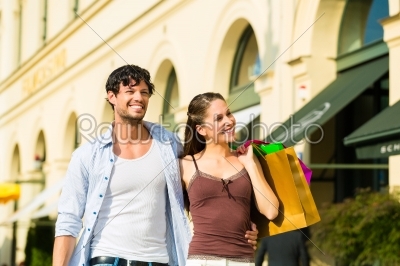 Couple shopping and spending money in city