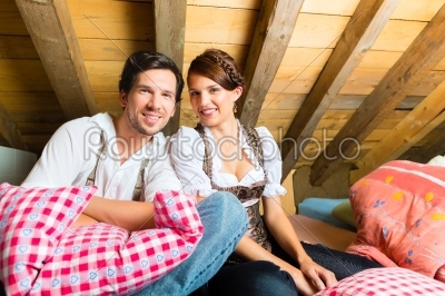 couple with bed clothes in mountain cabin