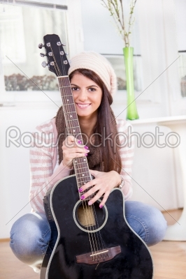 cute young girl holding the guitar