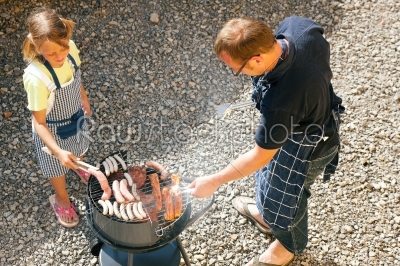 Dad and kid doing the BBQ