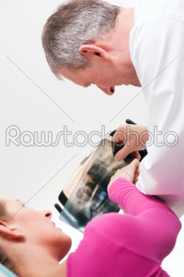 Dentist explaining x-ray to patient