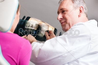 Dentist explaining x-ray to patient
