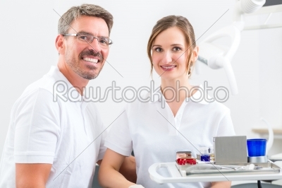 Dentists in their surgery or office with dental tools