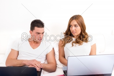 depressed and shocked young man looking at woman_qt_s computer