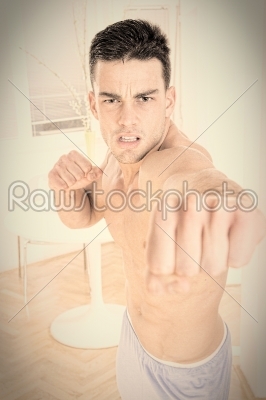 determined man fighter punching showing his fist