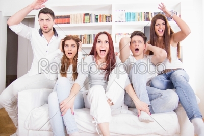 divided friends watching game cheering for different teams