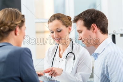 Doctor with patients in a consulting in clinic