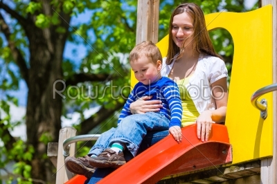 Family - Mother and son playing on a jungle gym