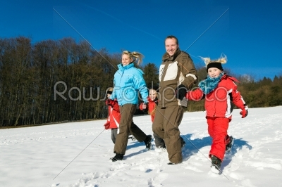 Family having a walk in the snow