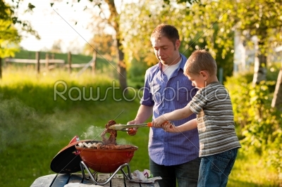 Family having barbecue in their garden
