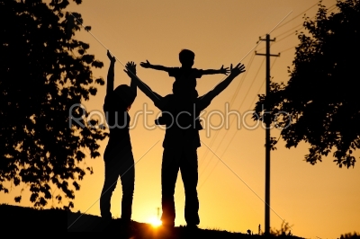 Family having walk at sunset