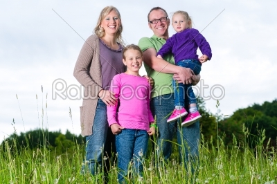 Family outdoors standing on grass
