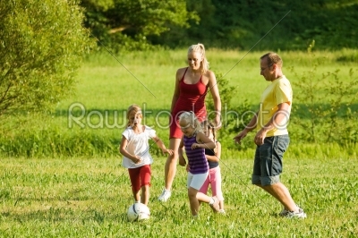 Family playing soccer