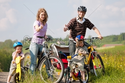 Family riding bicycles in summer