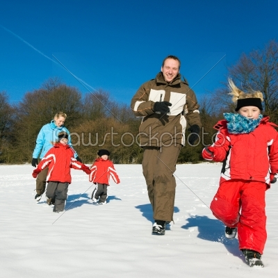 Family running in the snow