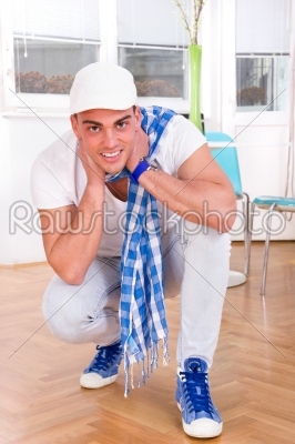 fashion man with a scarf and white cap posing