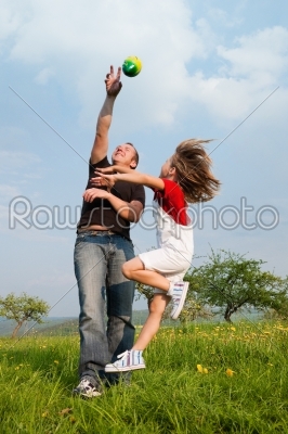 Father and daughter catching the ball