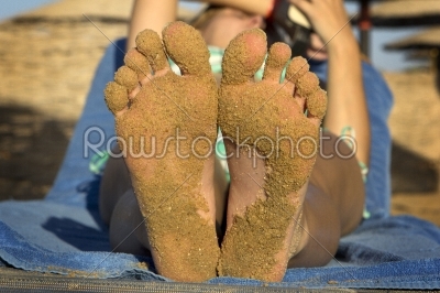 feet from woman with sand