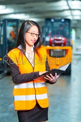 female employee or supervisor at warehouse
