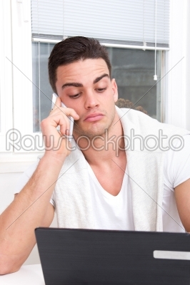 focused and surprised casual handsome man talking on mobile
