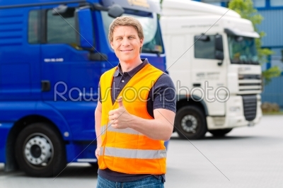 Forwarder in front of trucks on a depot
