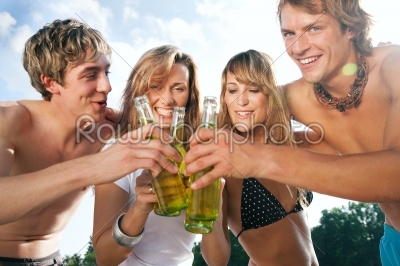 Four people celebrating beach party 
