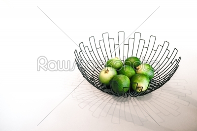 Fresh green lime fruit in a bowl
